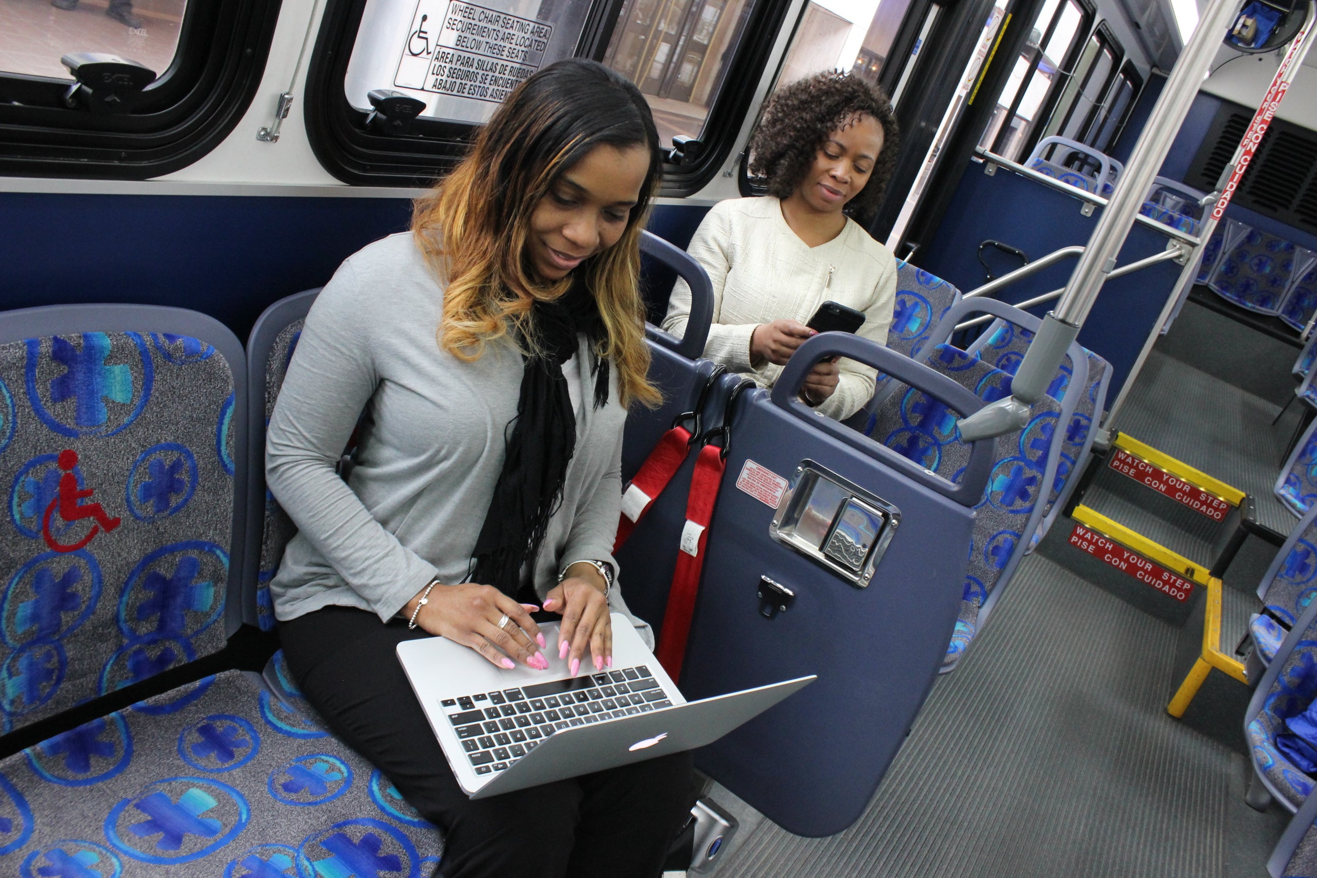 woman on laptop on bus