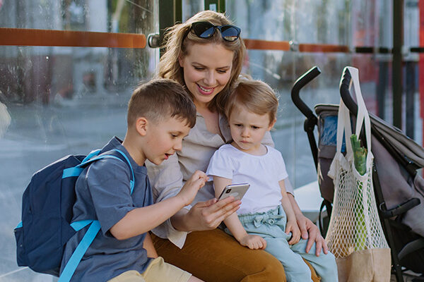 Family checking their phone while traveling